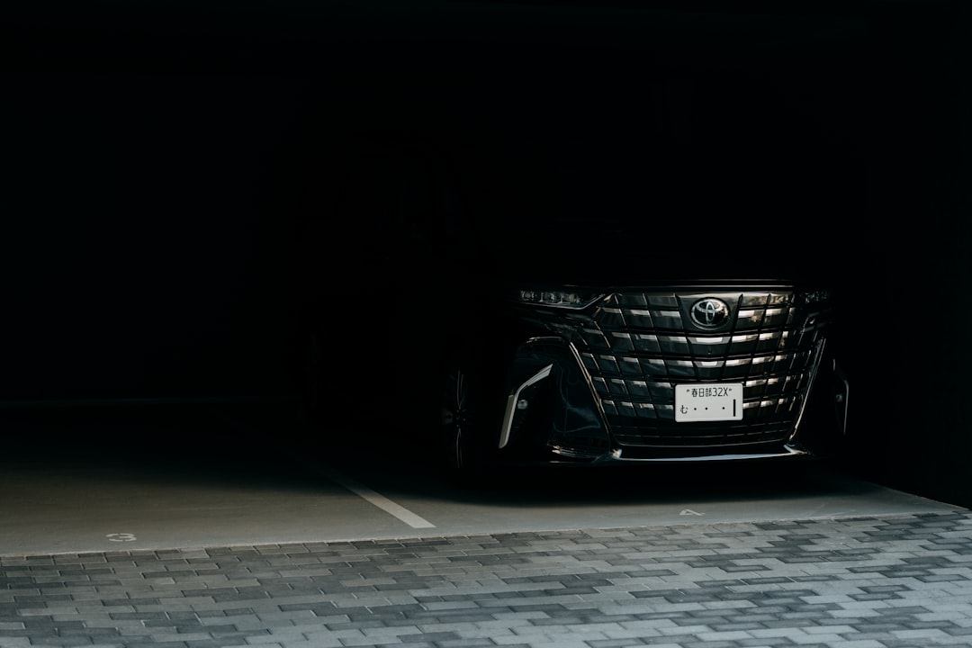 a-dark-luxury-car-parked-in-a-dimly-lit-garage-st8hqa1vcza