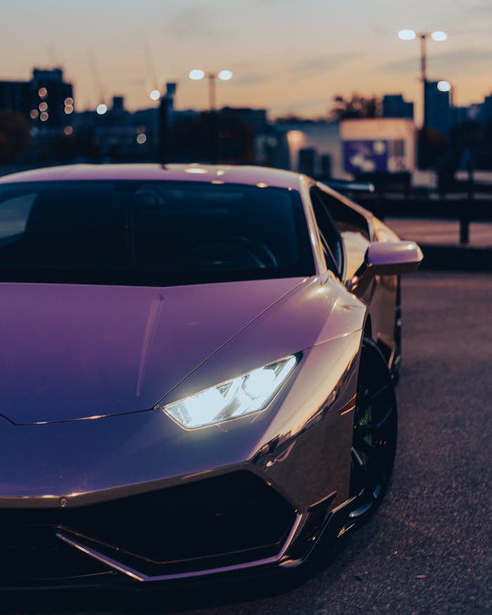 A sleek luxury sports car parked on an urban street at twilight, capturing modern automotive elegance.